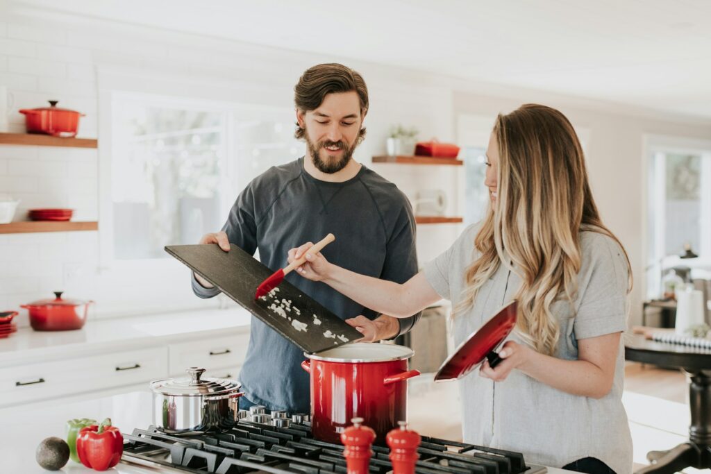 A young couple cooking together in their new home