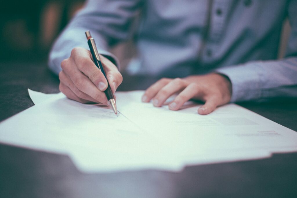 A buyer signing a purchase offer
