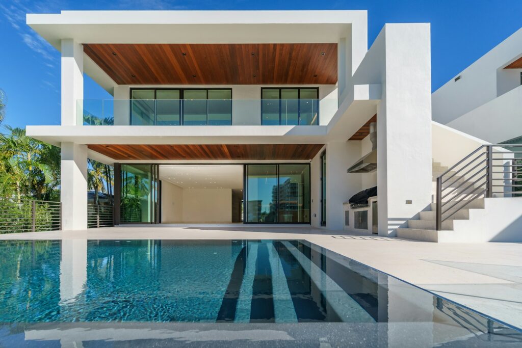 Modern villa with a flat roof and a lit swimming pool